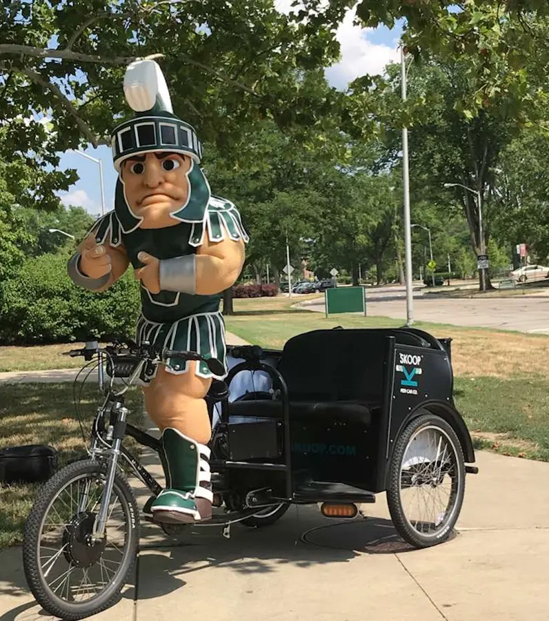 Sparty with a Skoop pedicab on Michigan State's campus